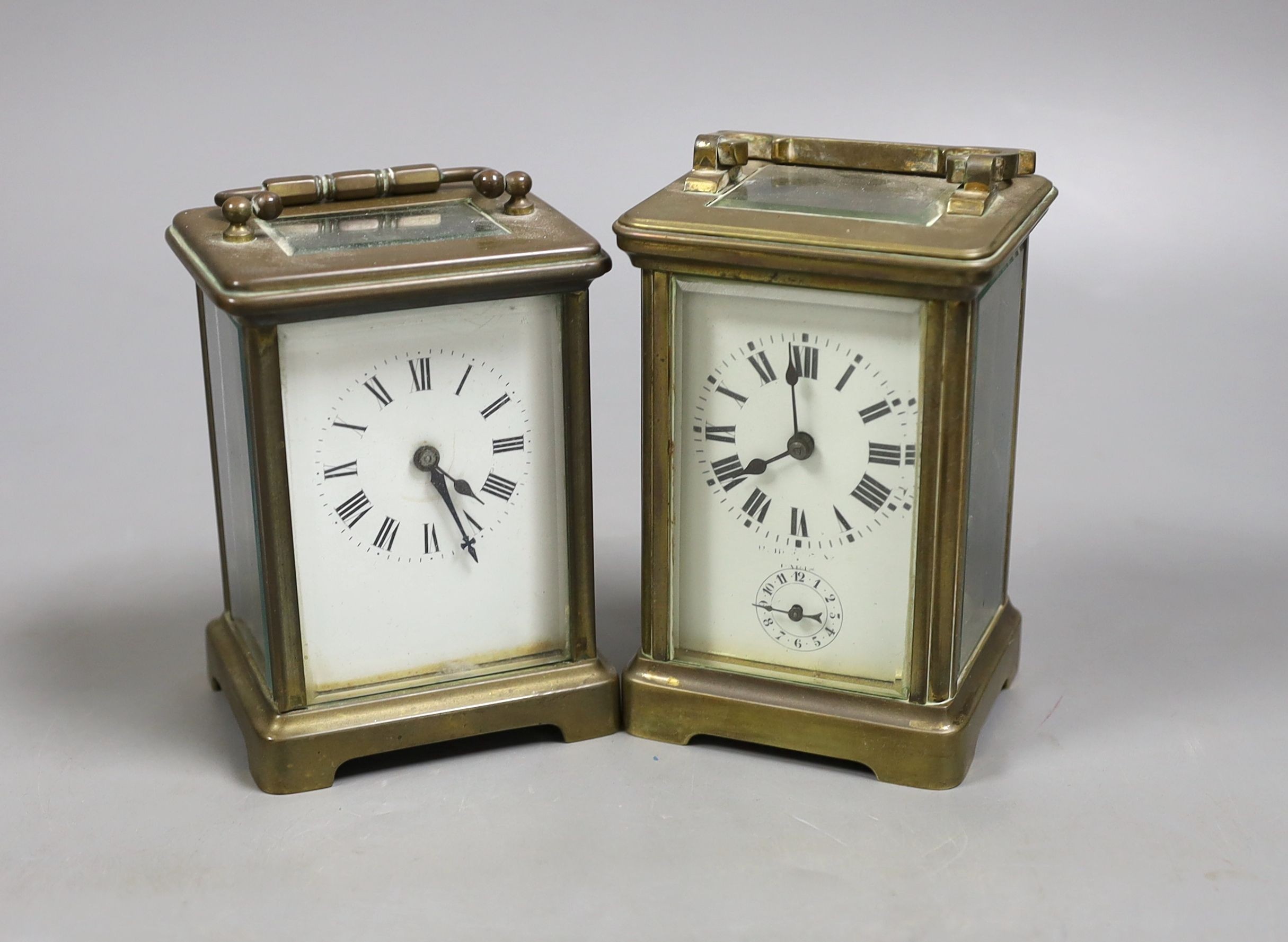 A French brass carriage timepiece with alarm and a French brass carriage timepiece, Tallest 11.5 cms high.